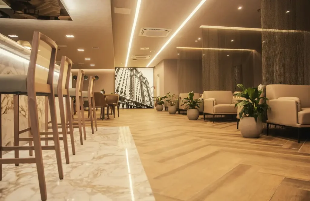 Interior da W Premium Lounge no Terminal 1 do Aeroporto Internacional de Guarulhos (GRU), com área de descanso, poltronas, balcão e ambiente sofisticado para passageiros em 2026.