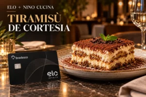 Cartão Elo ao lado de tiramisù em restaurante italiano, representando o benefício de cortesia no Nino Cucina.